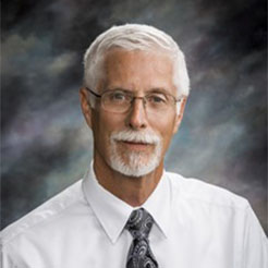 Dr. Bill Bekemeyer in white shirt and tie