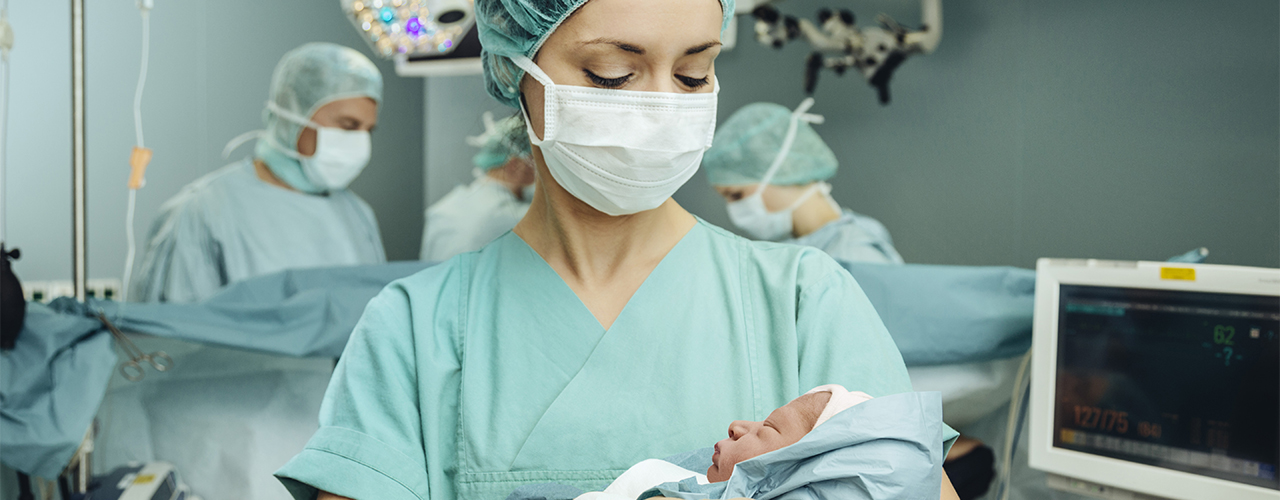Caregiver holding newborn baby
