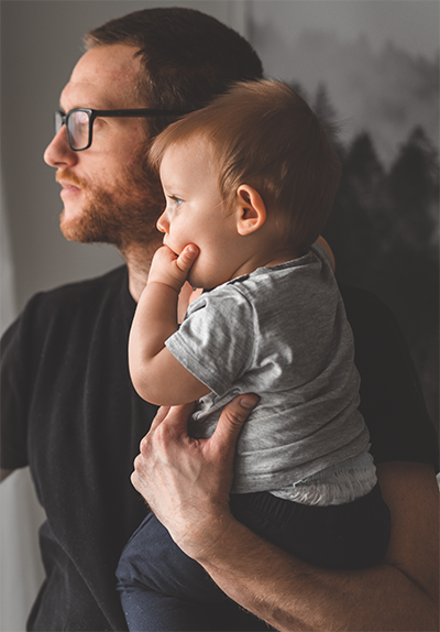Father holding baby and looking into the distance