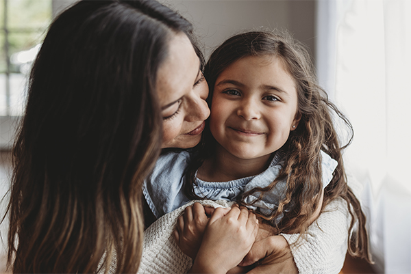 Mother holding preschool daughter