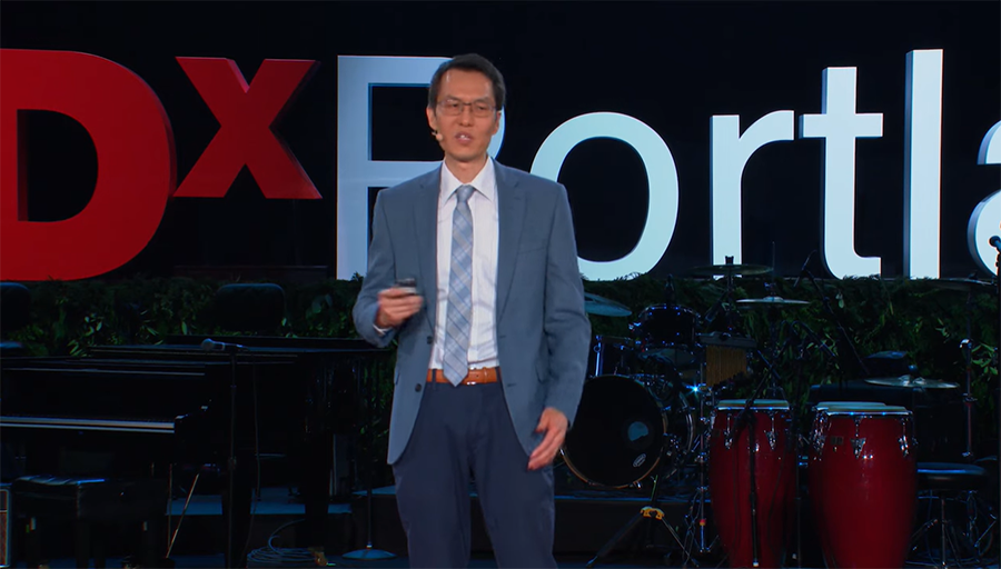 Eric Tran on stage at TedX Portland