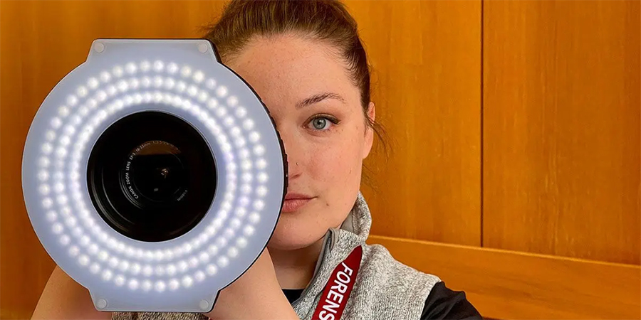 Nurse behind a forensic camera