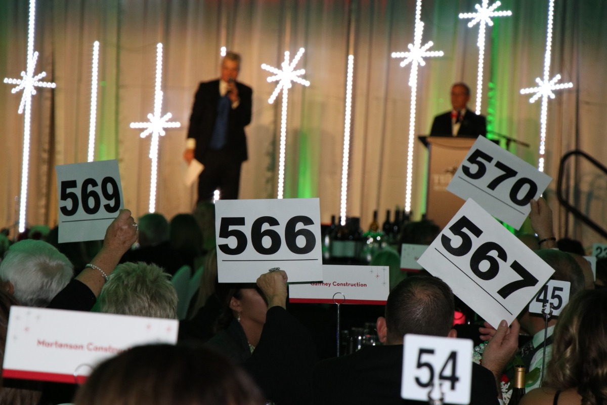 Bidders holding up auction numbers