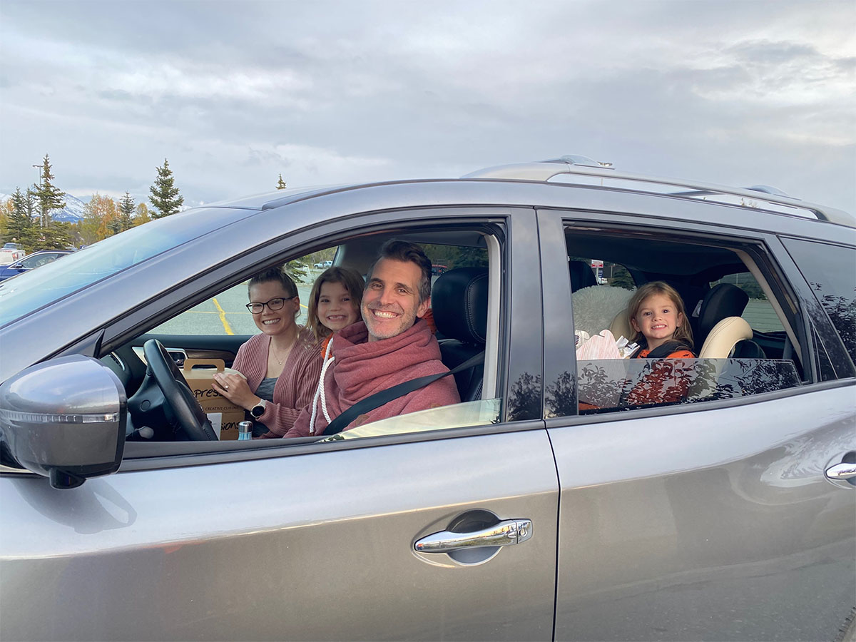 Parents and two children in vehicle at the drive-in