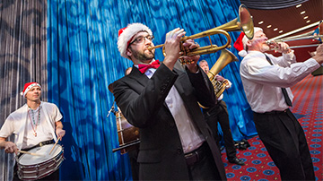 Men in Santa hats playing horns