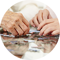 Two pairs of hands working with puzzle pieces