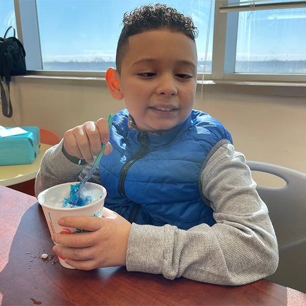 Young patient celebrating with snow cone at Bahama Buck's