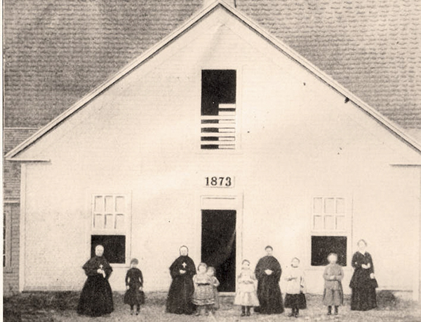 Historical photo of sister and children in front of original St. Pat's in 1873