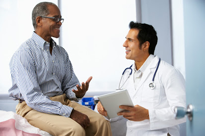 Male doctor with patient and tablet