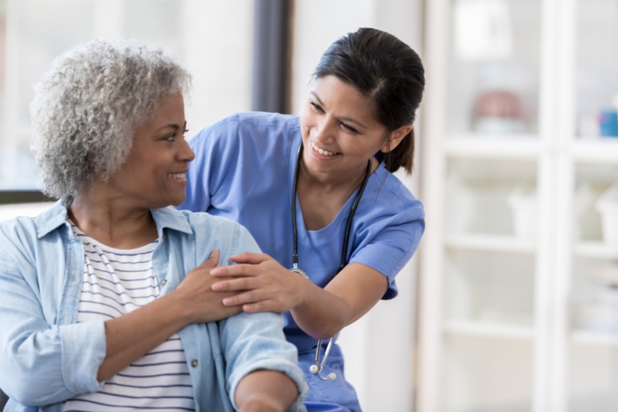 Caregiver patting patient on shoulder
