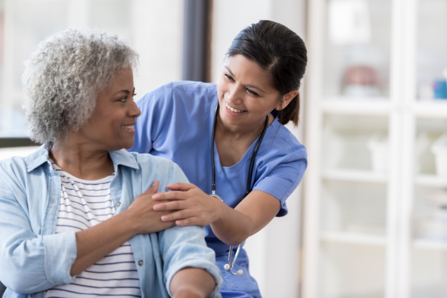 Caregiver and Patient Caregiver patting patient on shoulder