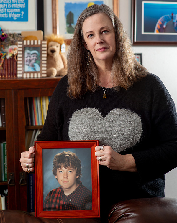 Kimberly Starr holding framed photo of son
