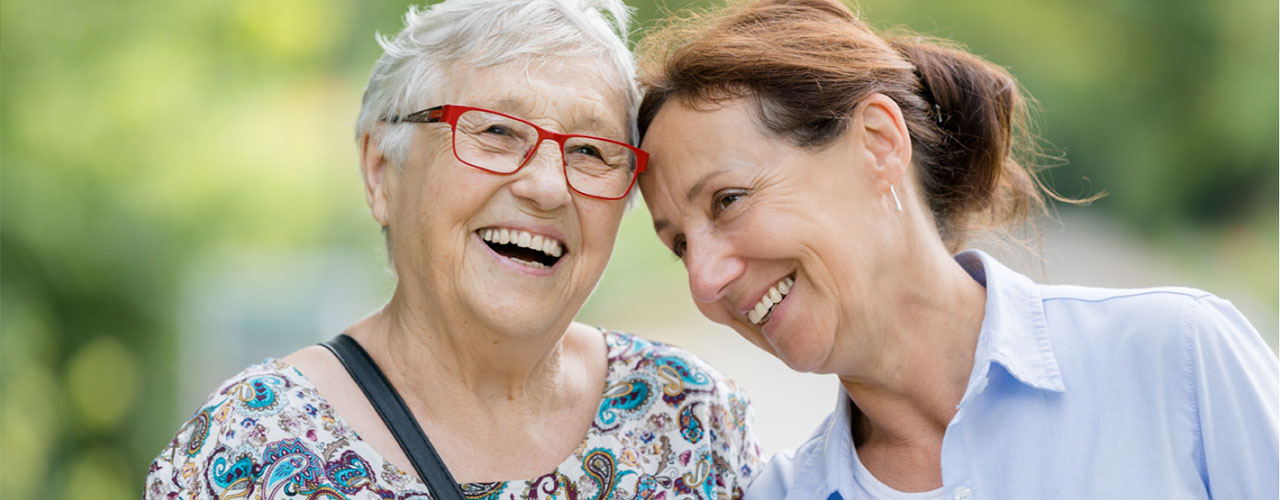 Join Our Board Elderly woman and middle aged woman walking and laughing