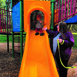 Melissa Hansen help grandson on slide