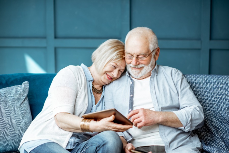 Elderly Couple Smiling elderly couple looking at tablet device