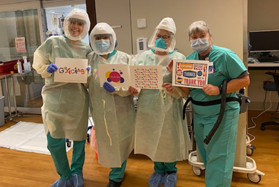 ICU Thank You Four caregivers holding thank you signs
