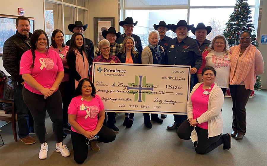 Cowboys and women in pink with large presentational check