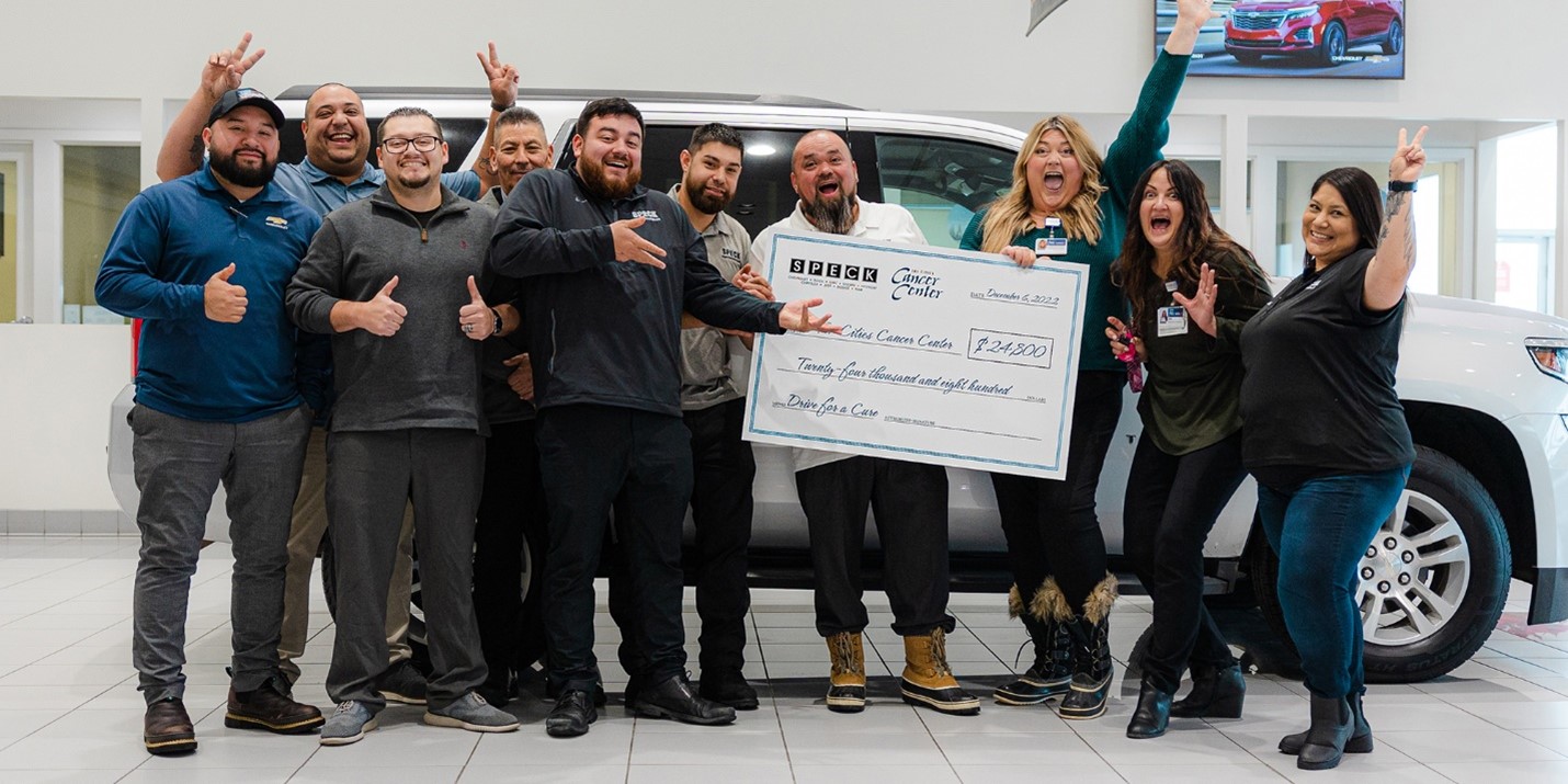 Event Fun Foundation staff smiling and holding oversized check