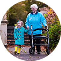 Elderly woman using walker and holding hands with granddaughter
