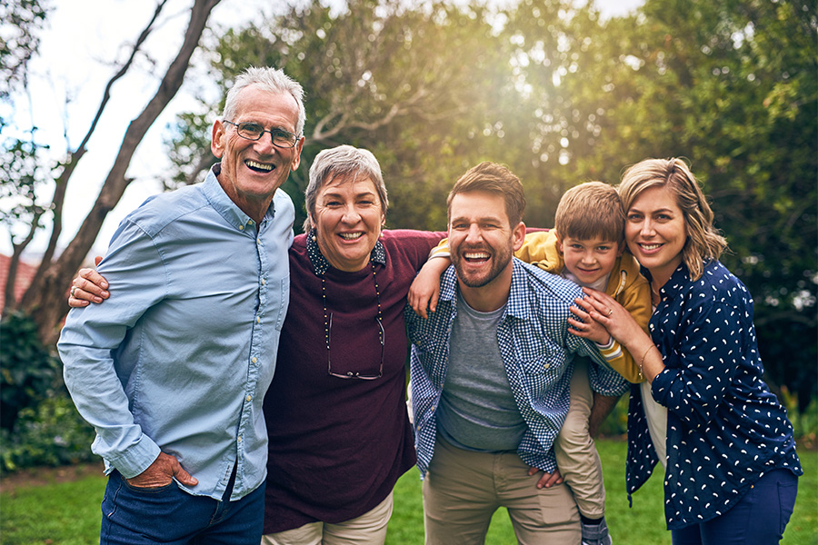 Happy Intergenerational Family Smiling grandparents, parents and toddler.