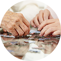 Two sets of hands working on a puzzle