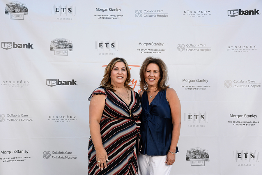 Sponsorships Two women in front of step-and-repeat.