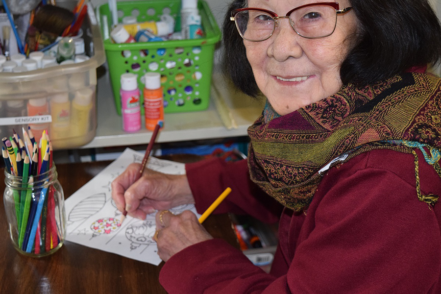 Art at Day Health Day Health participant works on drawing