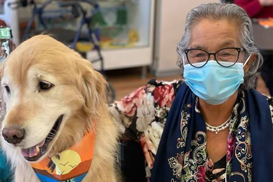 Therapy Dog Day Health participant and golden retriever therapy dog