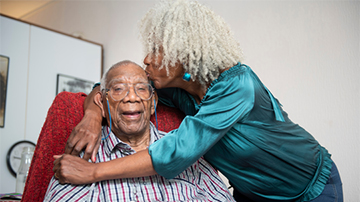 Elderly Woman Kisses Elderly Man