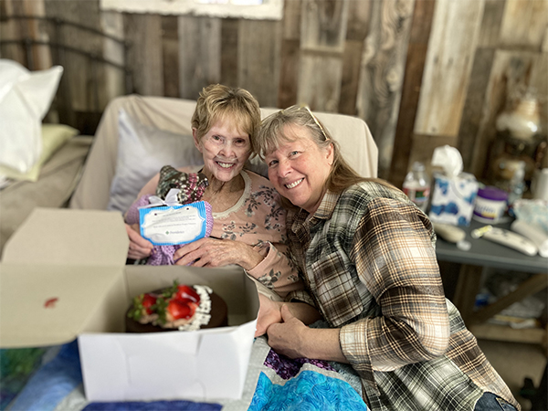 Woman in hospital bed holding birthday cake